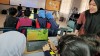 Over-shoulder view of a class of school students playing the 'Clean the River' game on laptops thumbnail